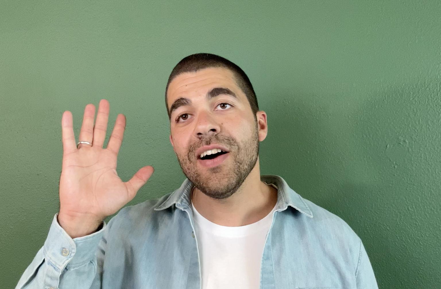 Man waving against green background, representing personalized communication and direct viewer engagement.
